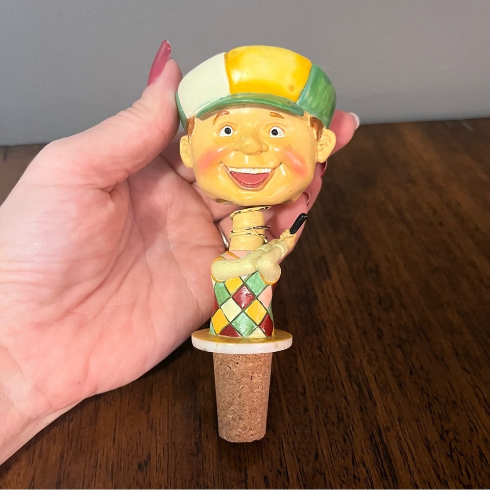 Vintage ceramic golfer bottle stopper with a bobblehead design.